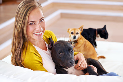 Buy stock photo Portrait, woman and dogs on sofa in house, home and living room with affection for pets. Female person, puppies and smile in apartment, lounge and place of residence in Paris on couch to relax