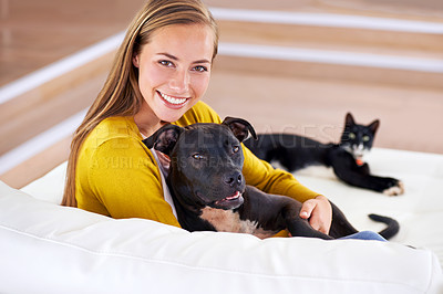 Buy stock photo Woman, pets and relax on sofa in portrait, smile for dog and cat love with bonding at home. Happy, positive and trust with foster or adoption, cuddle puppy in living room and domestic animal care