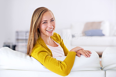 Buy stock photo Portrait of an attractive young woman relaxing on her sofa at home