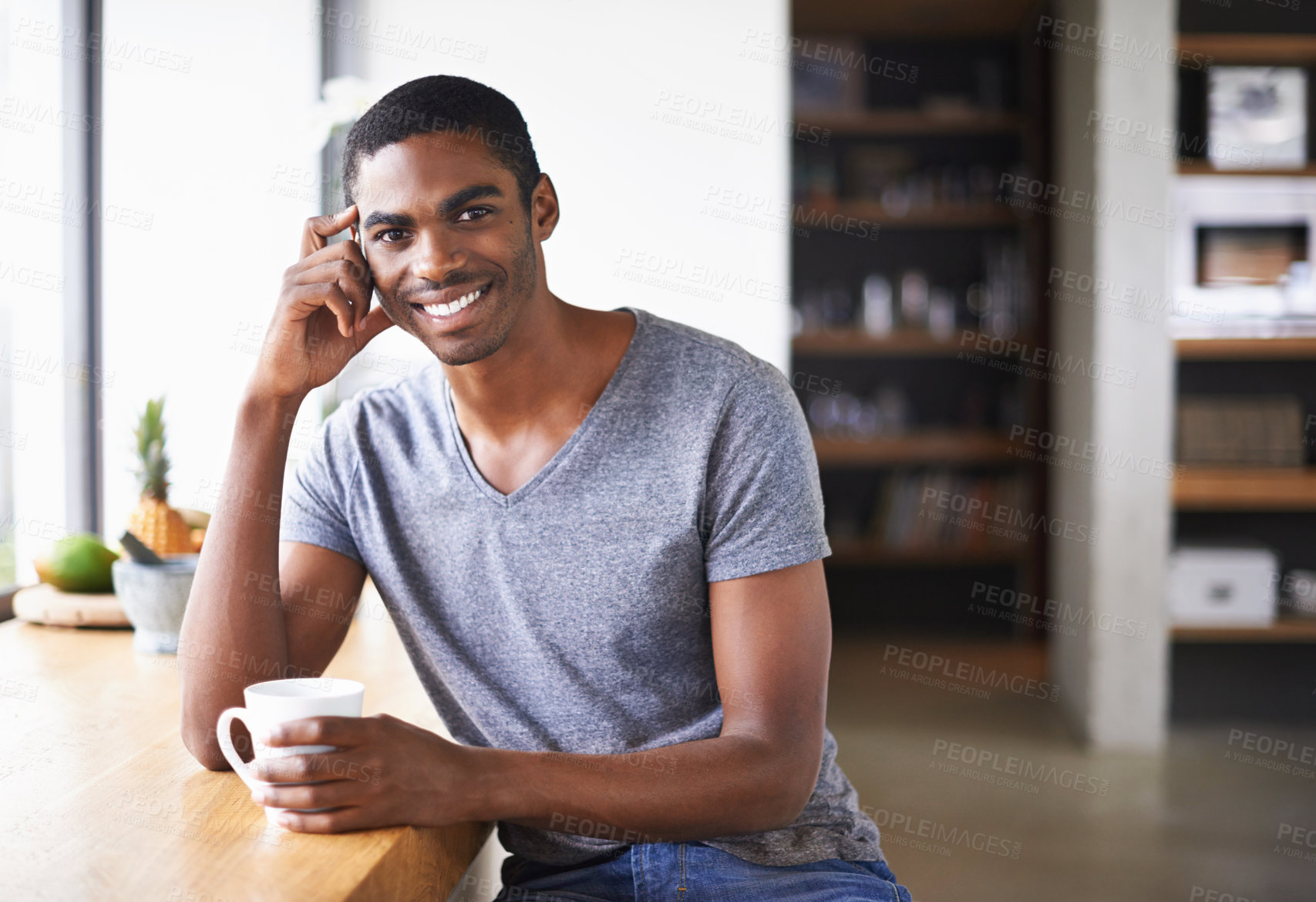 Buy stock photo African, man and kitchen table and coffee smiling, relax and happy morning at counter. Confident and male person, positive portrait with hot beverage in apartment, energy and espresso at window