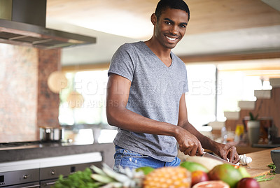 Buy stock photo Man, fruit and vegetables with knife in portrait for cooking, salad and happy in home kitchen. African person, smile and pride with food, nutrition and vegan diet for health, wellness and meal prep