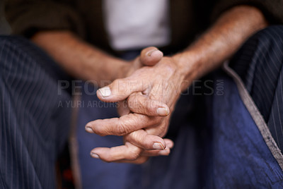 Buy stock photo Cropped shot of a man sitting with his hands together