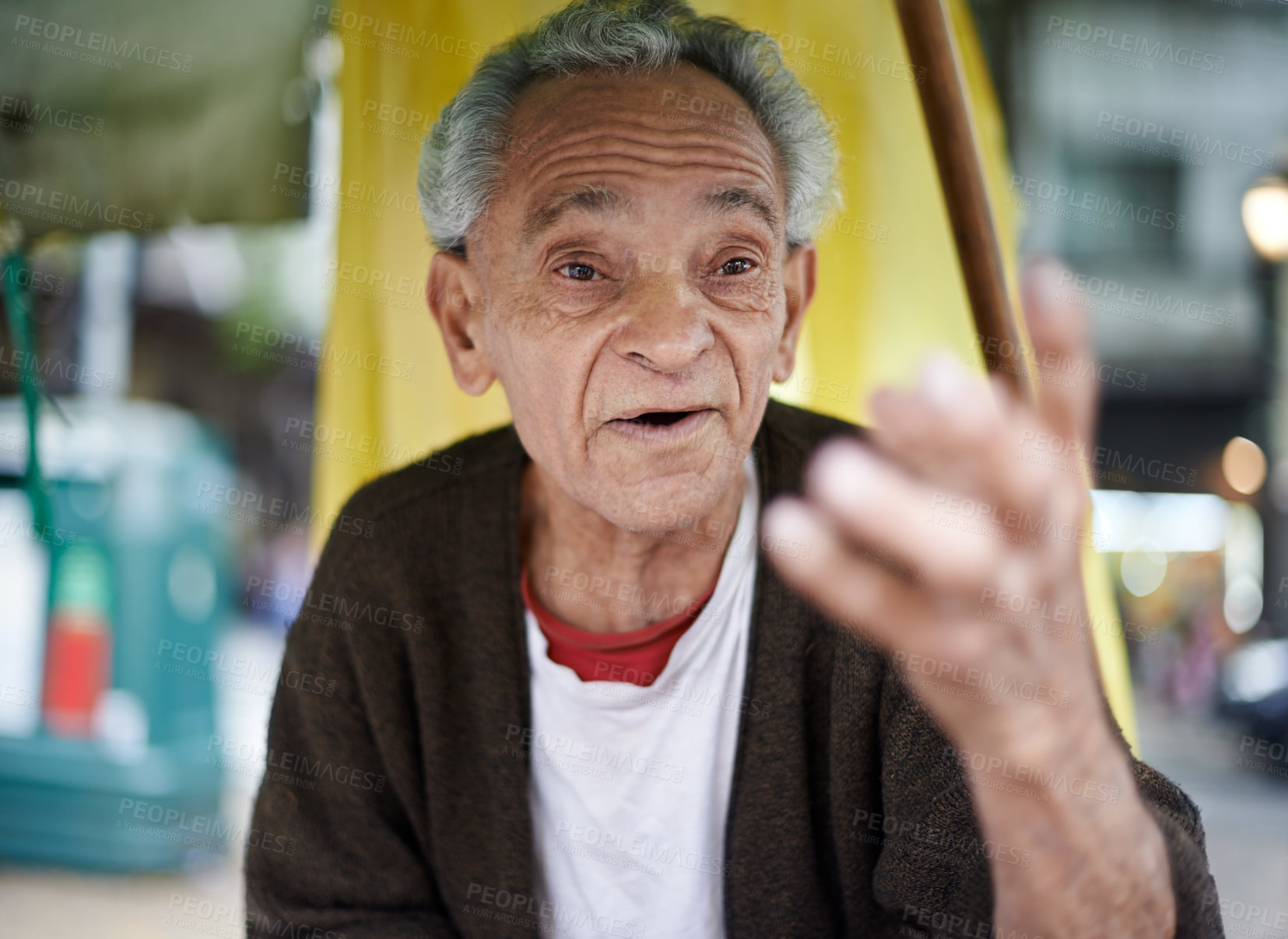 Buy stock photo Conversation, city and senior man talking in a neighborhood outdoor with chat and communication. Urban, sitting and Asian male person with wisdom, street and road with travel and advice with gesture