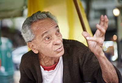 Buy stock photo Conversation, city and elderly man on journey in a neighborhood outdoor with chat and communication. Urban, sitting and senior Mexican male person with wisdom, street and road with travel and advice