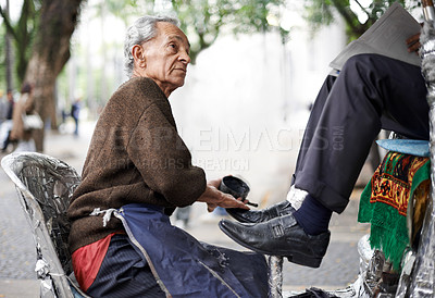 Buy stock photo Shine, shoes or old man in city, street or cleaning service for client or customer with polish, trade or job. Chair, senior or feet of businessman in downtown Sao Paulo for footwear or outdoor help