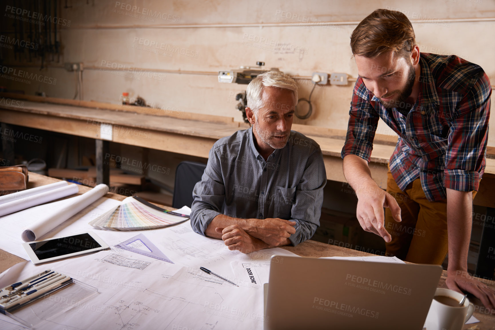 Buy stock photo An architect drawing up plans