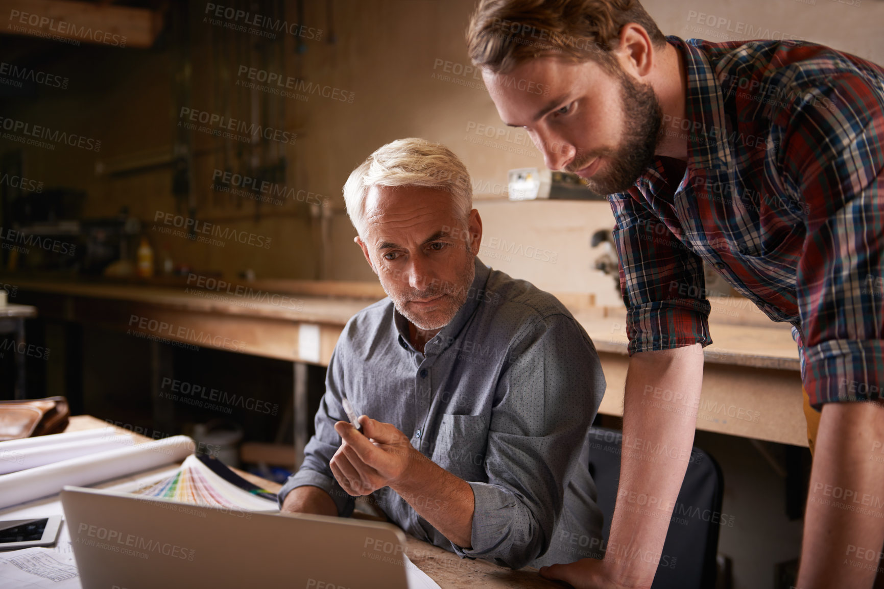 Buy stock photo Architects, teamwork and father and son with laptop in workshop for building construction. Senior engineer, men and computer with trainee or apprentice working on design and planning with mentor.