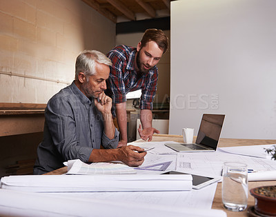 Buy stock photo An architect drawing up plans