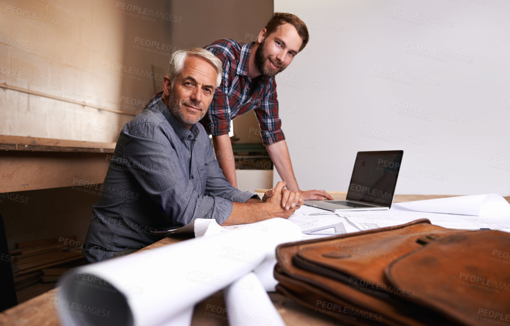 Buy stock photo Architects, teamwork and portrait of men in workshop with blueprint for building construction. Senior engineer, father and son working on design, project and planning of happy apprentice and mentor.