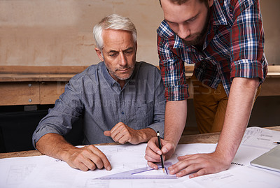 Buy stock photo Architects, collaboration and men with blueprint in workshop for building, construction or repairs. Engineering, design and industrial apprentice planning and working on industry project with mentor.