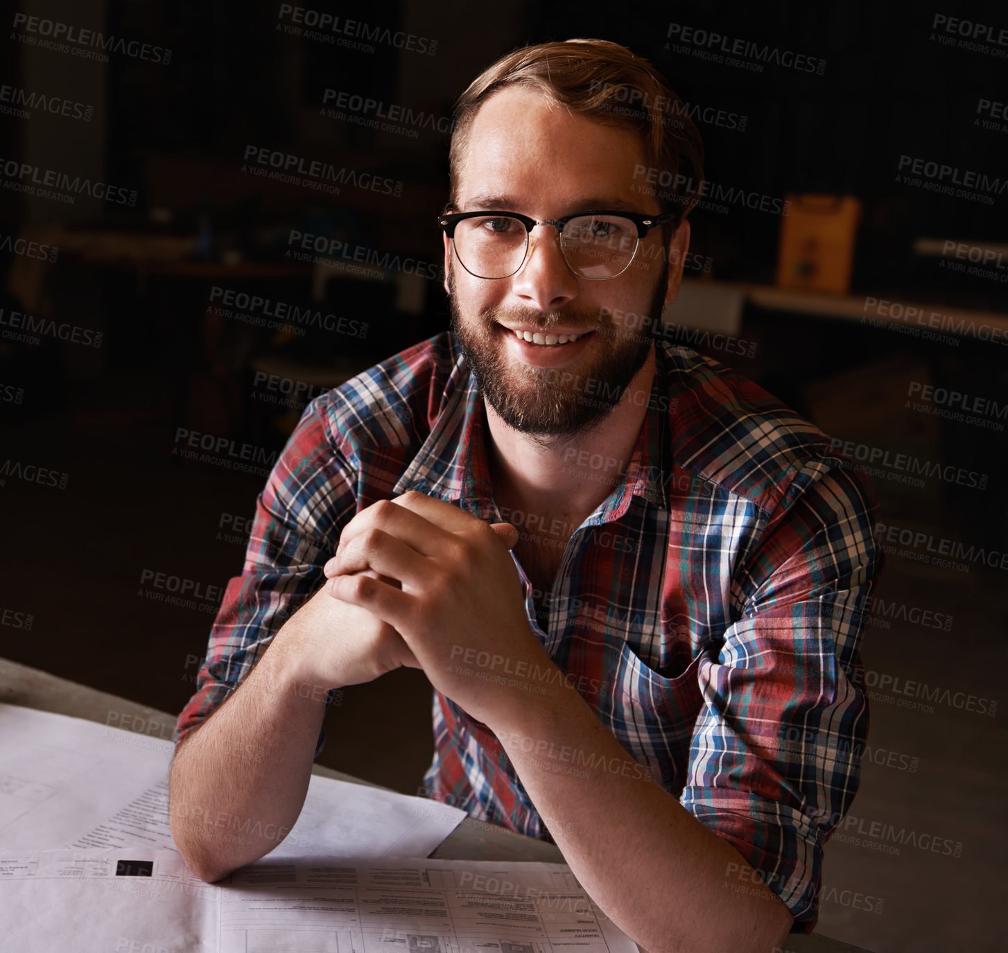 Buy stock photo Portrait, man and architect with documents in workshop on wooden table for paperwork of startup. Confident, entrepreneur and male person with smile for small business in industry for construction