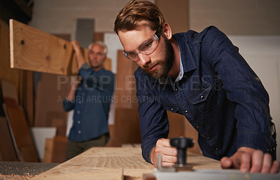 Buy stock photo Carpentry collaboration, carpenter and men work in workshop on design project with vocation and creative skill. Teamwork, male worker cutting wood with power tools and father and son working together