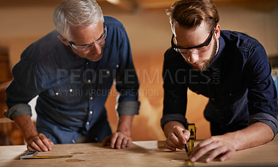 Buy stock photo Teamwork, carpenter and apprentice in workshop, wood measurement and designer furniture manufacturing. Mentorship, carpentry and men at sustainable business, teaching and learning with design project