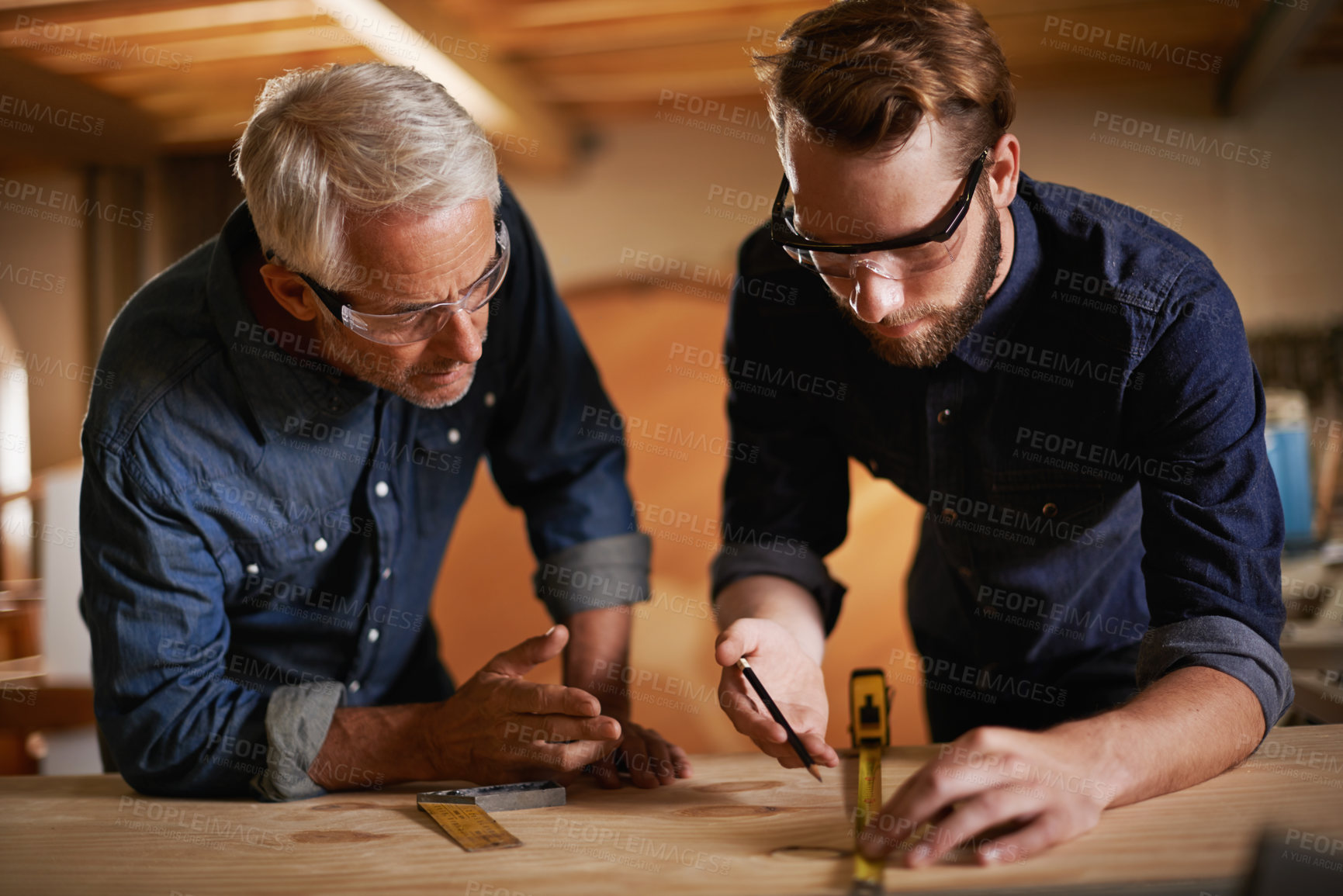 Buy stock photo Carpentry, men and measurement in workshop teaching and learning furniture design, manufacturing or internship. Mentorship, carpenter or apprentice at sustainable wood business or teamwork on project