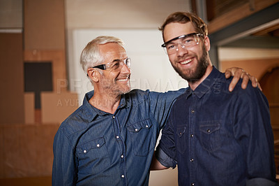 Buy stock photo Man, embrace and smile with wood, workshop and family business or apprenticeship. Mature father, son and hug with artisan, carpentry and together for startup and mentor or learning with happiness