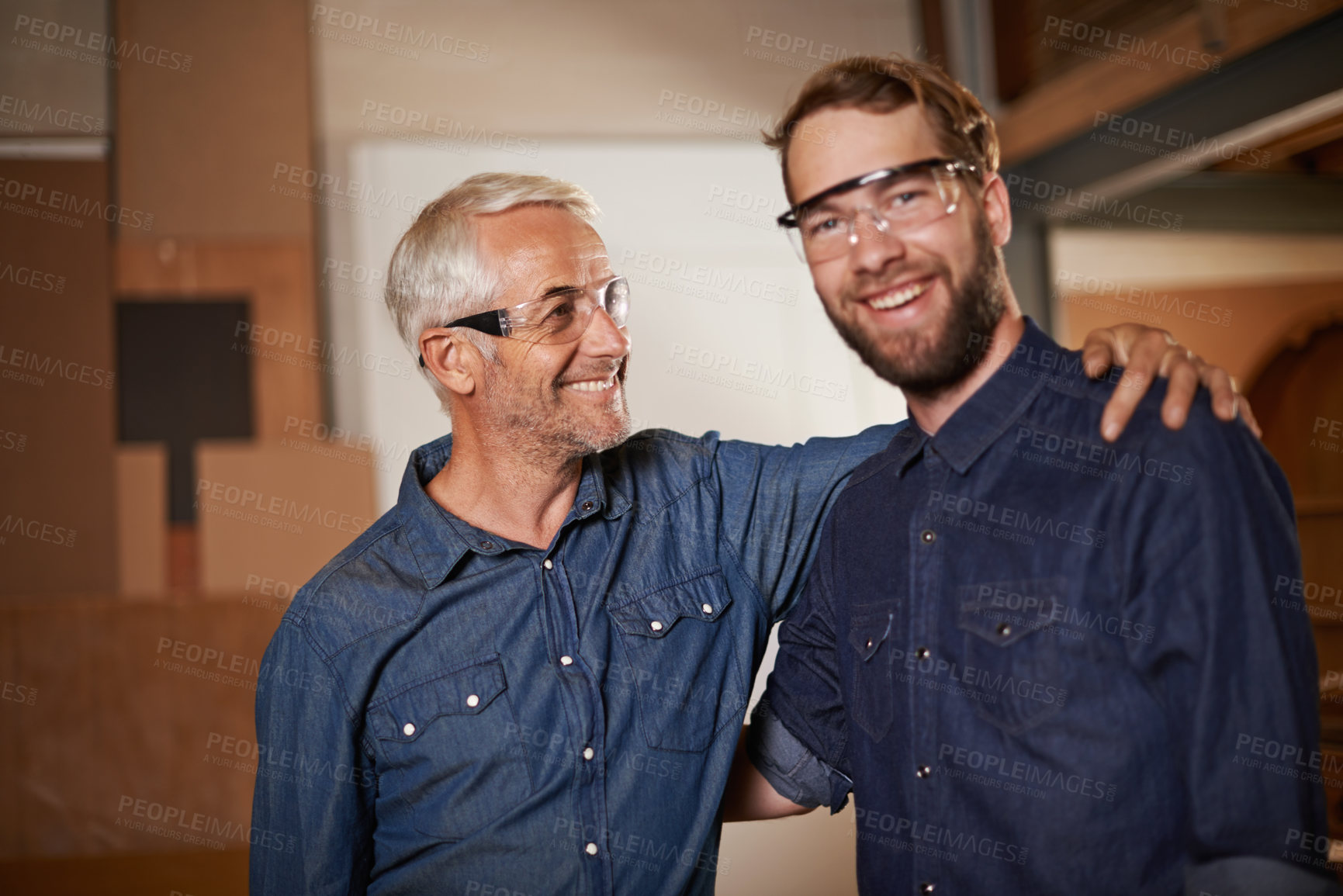 Buy stock photo Man, embrace and smile with wood, workshop and family business or apprenticeship. Mature father, son and hug with artisan, carpentry and together for startup and mentor or learning with happiness