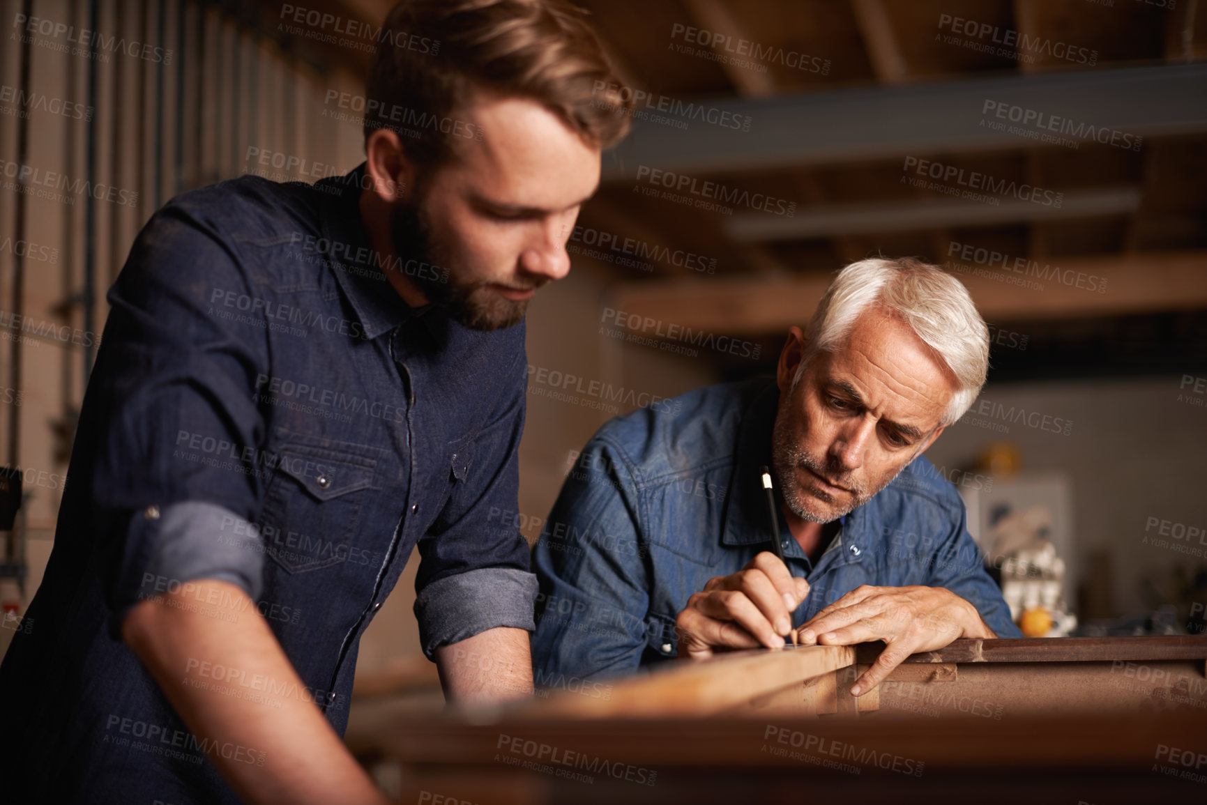 Buy stock photo Training, learning and carpentry apprentice with man, teaching woodwork and professional furniture manufacturing. Mentorship, expert carpenter and student working on sustainable wood project design.