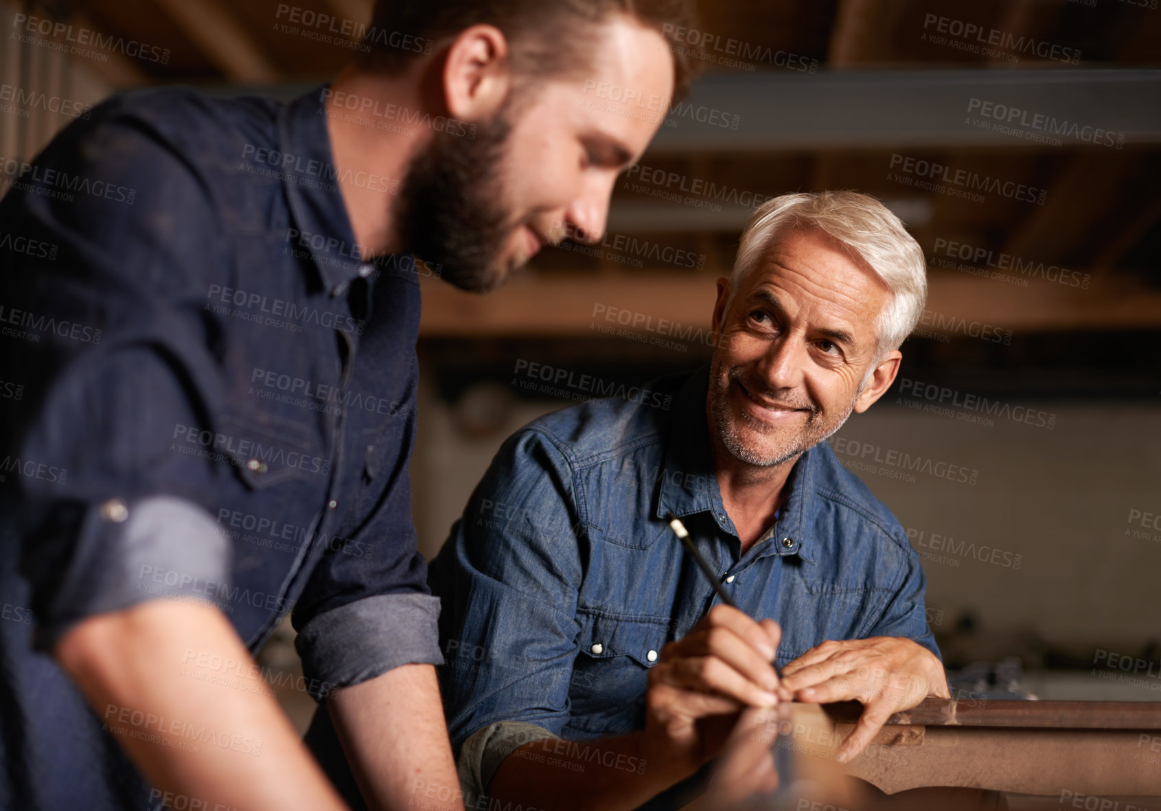 Buy stock photo Smile, learning and carpenter with apprentice in training, man teaching professional furniture manufacturing. Mentorship, expert carpentry and happy man with student working at wood project workshop.