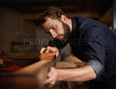 Buy stock photo Shot of a young artisan working intently in his workshop