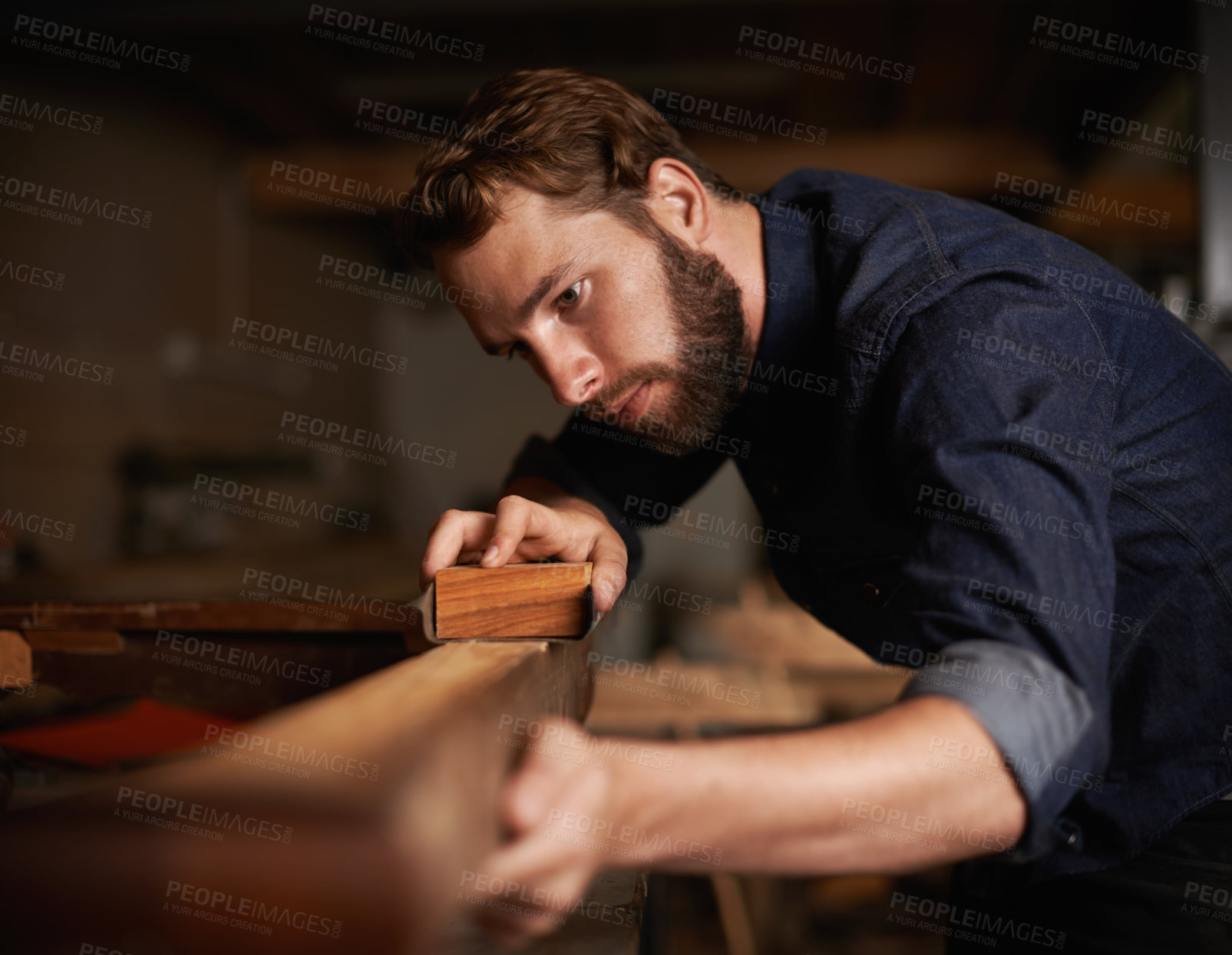Buy stock photo Shot of a young artisan working intently in his workshop