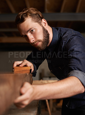 Buy stock photo Carpenter, wood sanding and man working on building construction and architecture project. Home improvement, maintenance and handyman work of a young male employee with carpentry tool for woodwork