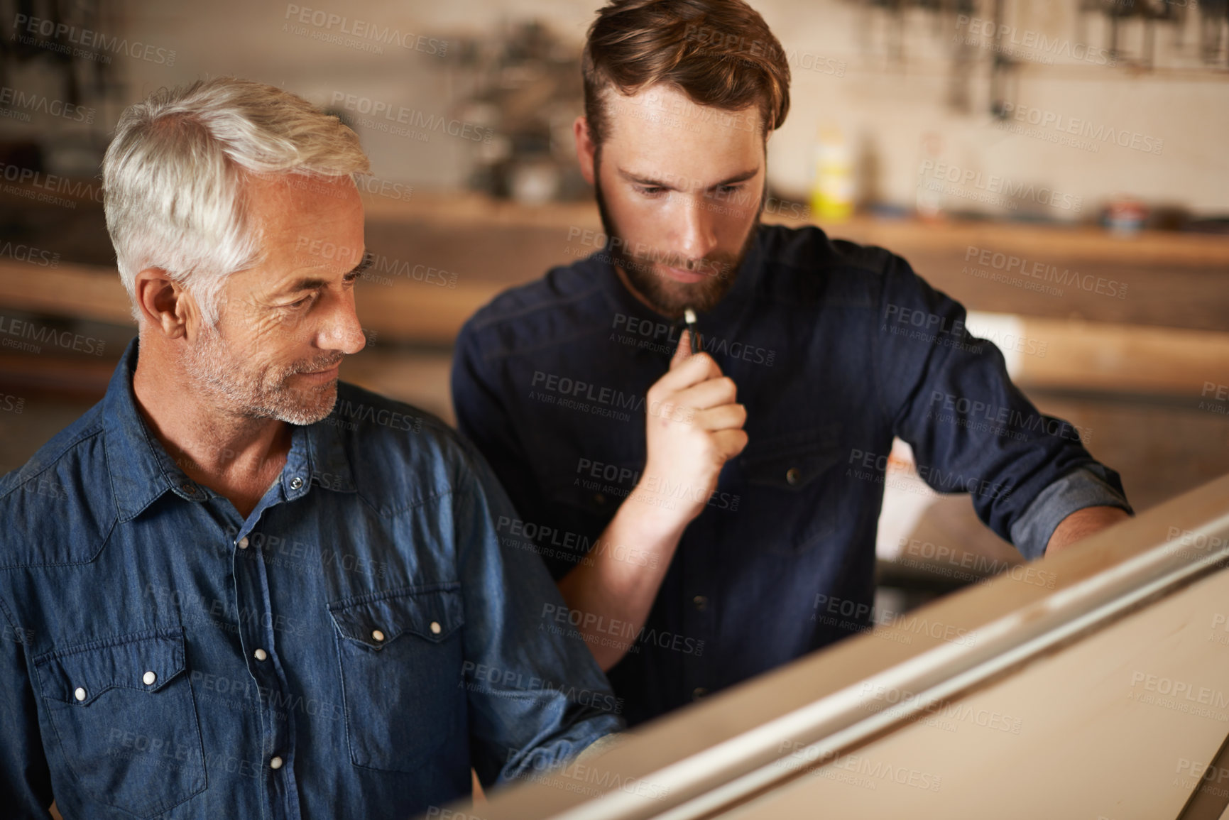 Buy stock photo Planning, discussion and architects by board in workshop for industrial carpentry project. Brainstorming, engineering and male industry apprentice working on ideas with mentor in office on site.