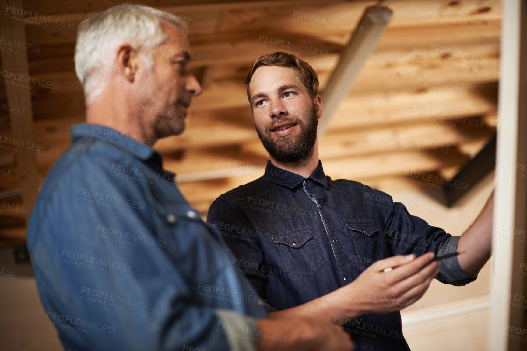 Buy stock photo Planning, teamwork and architects by board in workshop for industrial carpentry project. Brainstorming, engineering and male industry apprentice working on ideas with mentor in office on site.