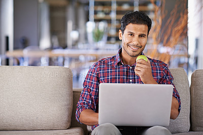 Buy stock photo Businessman, portrait and laptop with apple working, busy and smile on couch or sofa. Freelancer, career and male person in lounge with computer for technology and connectivity at home or living room