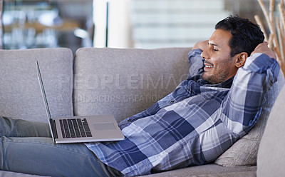 Buy stock photo A young man working on his laptop from home