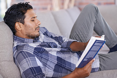 Buy stock photo Man, relax and couch with book for reading for information or knowledge, development and quiet time for comfort. Male person, leisure and literature novel for learning or contentment and inspiration.