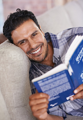 Buy stock photo Man, portrait and reading a book for knowledge in home, literature and information. Happy male person, story and fiction novel for education in living room on weekend, comfortable and relax on sofa