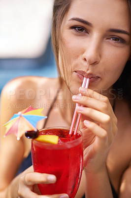 Buy stock photo A young woman sunbathing next to the pool