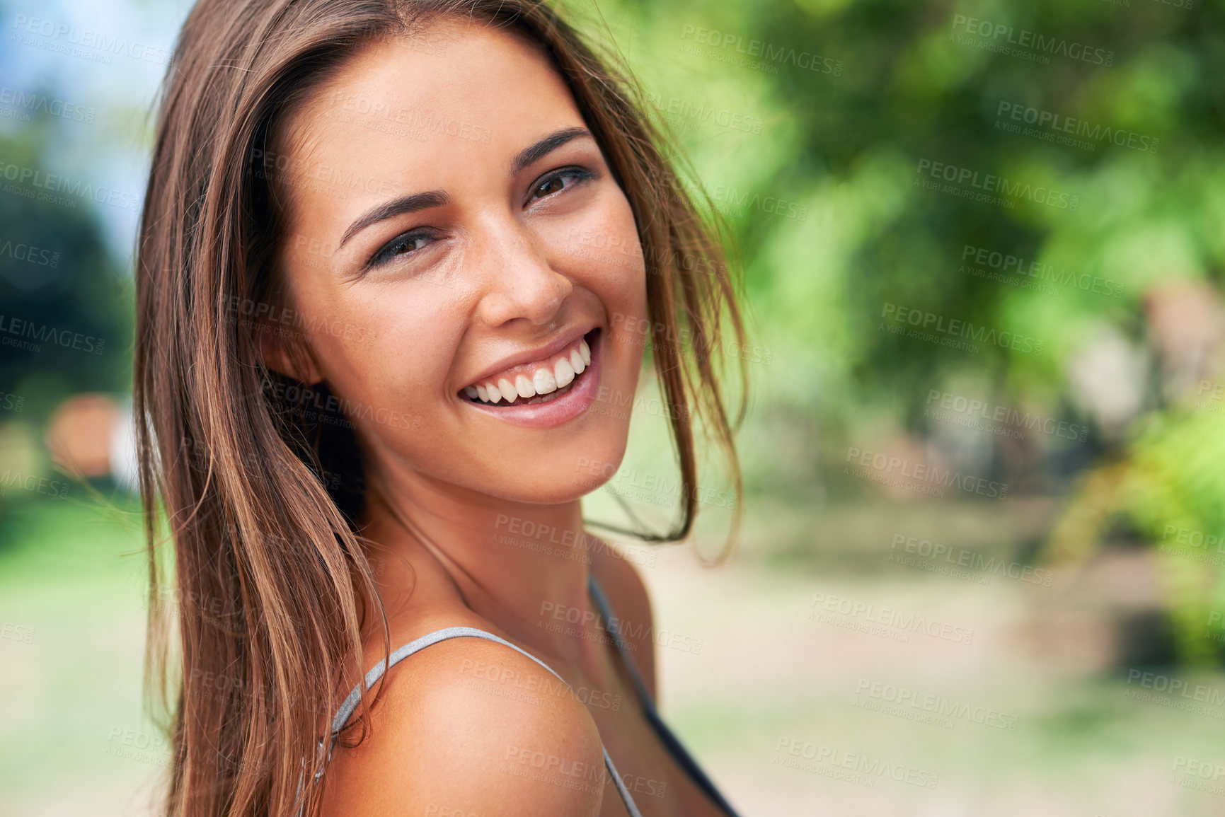 Buy stock photo A beautiful young woman smiling outdoors