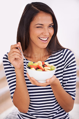 Buy stock photo Fruit, portrait and wink with healthy eating woman, bowl and happy for fresh food. Natural, nutrition and sustainable for vegetarian, fiber and breakfast or dessert for minerals and vitamins 