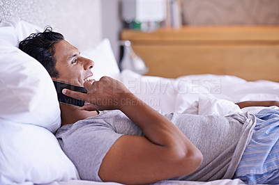 Buy stock photo Bed, smile or phone call with a happy man to relax in communication, morning or connection. House, wake up and male person resting in home talking on a mobile for news, listening and conversation