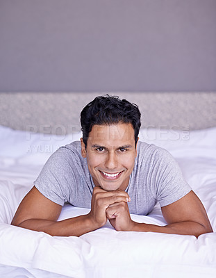 Buy stock photo Portrait of a handsome young man lying on his bed at home