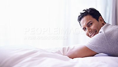 Buy stock photo Man, smile and portrait on bed for happy and relax at home or indoor on weekend and alone. Young person, attractive or handsome for unwind, rest or chill in apartment on mattress inside South Africa