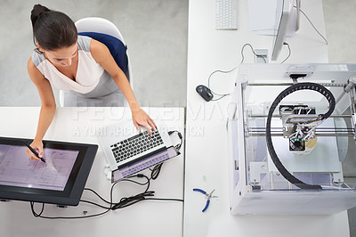 Buy stock photo Cropped shot of an attractive young woman working beside a 3D printer