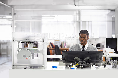 Buy stock photo Cropped shot of a young man printing his designs on a 3D printer