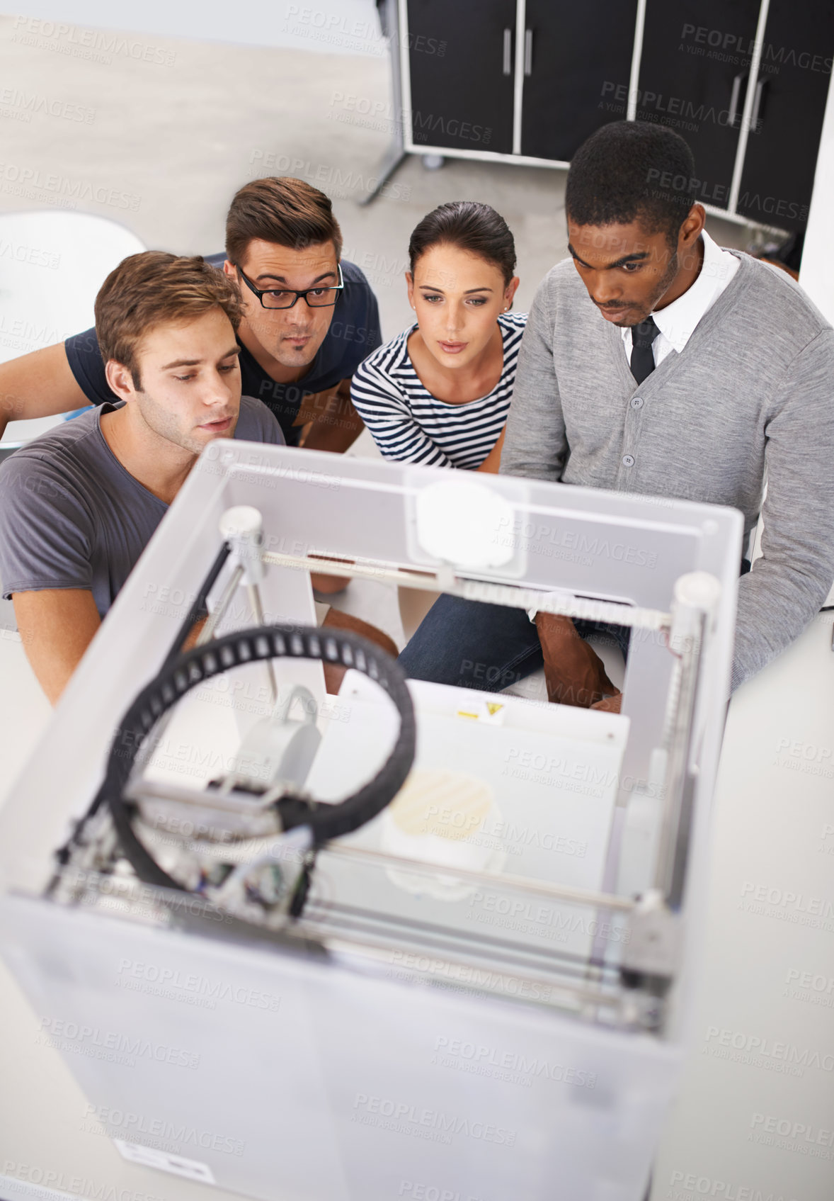 Buy stock photo Engineering, team and working with 3D printer in office for project, collaboration and above rendering machine. People, designer and excited for robotic printing prototype in manufacturing process