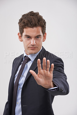Buy stock photo Businessman, hand and stop with sign for rejection, no or decline on a gray studio background. Young man, model or employee showing palm, gesture or symbol for wait, warning or refusal on mockup