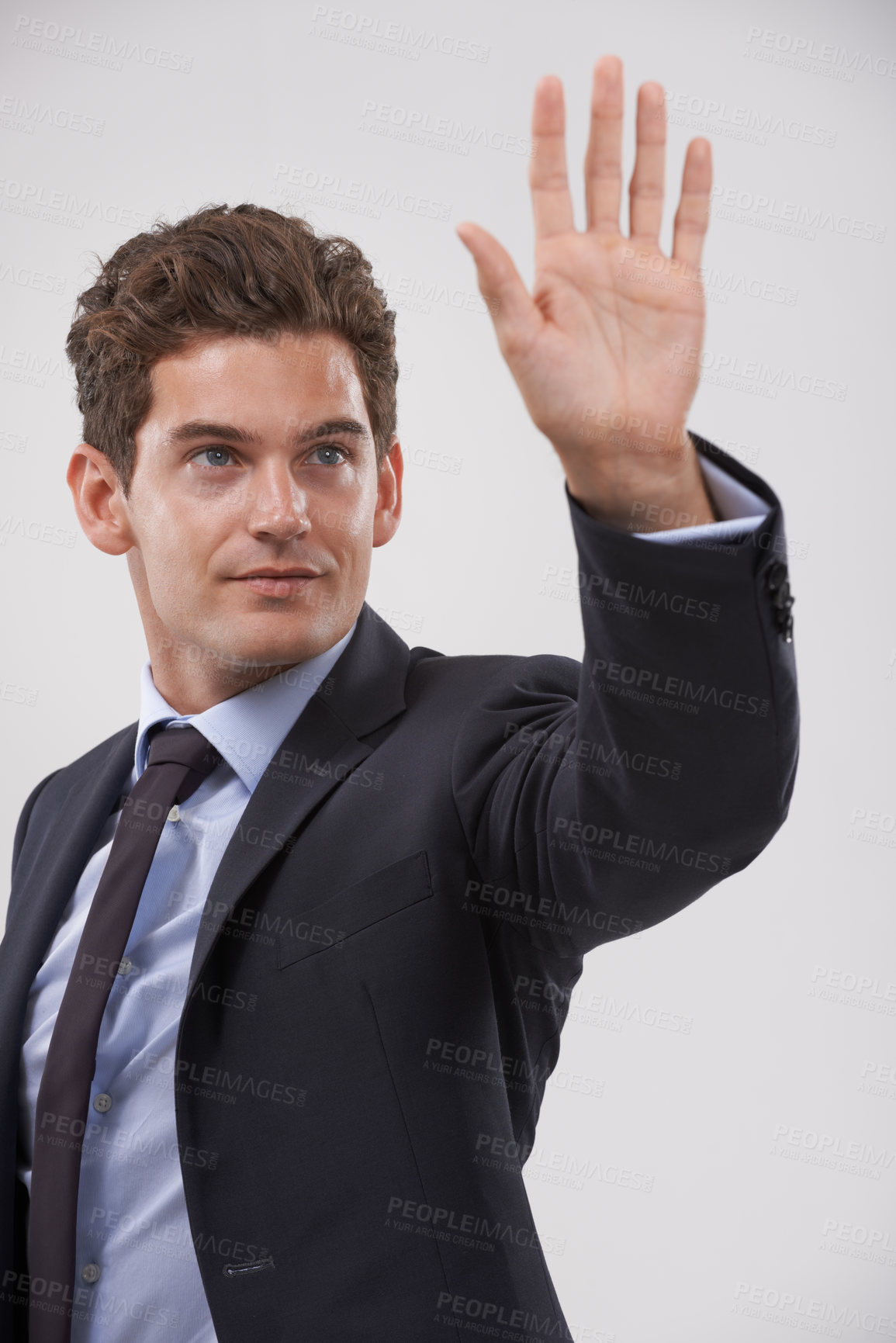 Buy stock photo Businessman, palm and hand with touch for interaction, virtual display or connection on a gray studio background. Isolated young man, user or business employee showing gesture sign, symbol or wait