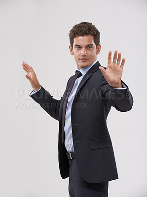 Buy stock photo Future, innovation and internet with businessman user in studio on white background for metaverse access. Corporate, digital transformation and touchscreen networking with young employee in suit
