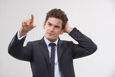 Buy stock photo Confused, thinking or businessman on touchscreen in studio on white background for metaverse access. Fail, air and software system with finger pointing, doubt and employee in suit for networking
