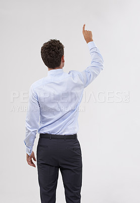 Buy stock photo Rear view of a handsome young businessman touching a transparent digital interface