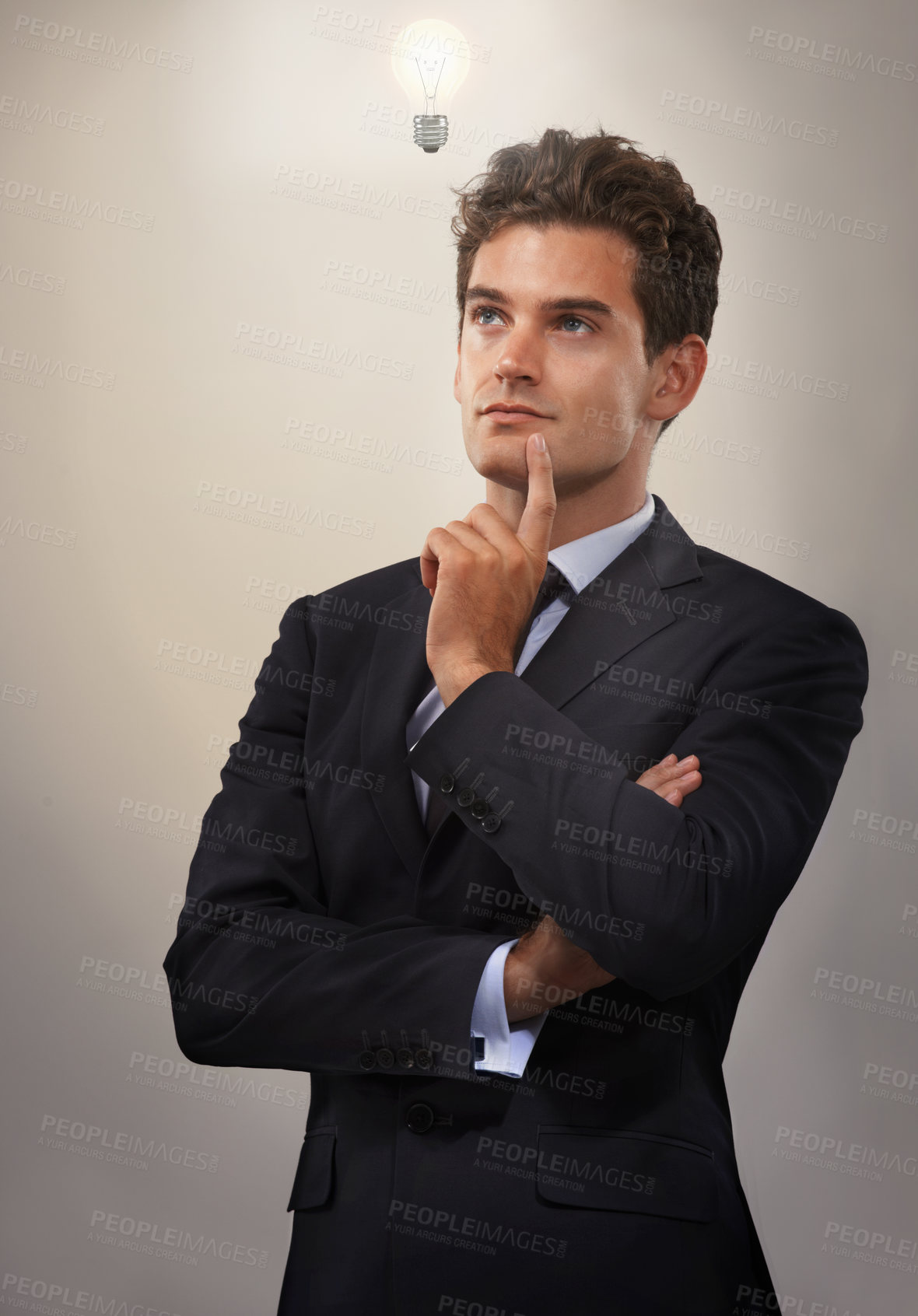 Buy stock photo Businessman, suit and thinking in studio with lightbulb for inspiration, ideas and creativity in career or job. Young man, attorney or executive with finger on chin for solution, plan and answer  