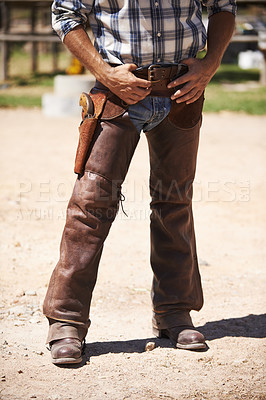 Buy stock photo Farm, nature and legs of cowboy on ranch with weapon for horse, cows and rodeo animals for agriculture. Farming, costume and closeup of man in environment, countryside and working outdoors in Texas