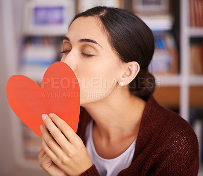 Buy stock photo Woman, kiss and heart card in home for valentines day, memory and happy for celebration with sign. Girl, person and love letter for romance, kindness and notes for relationship with care in apartment