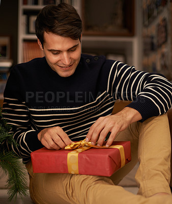 Buy stock photo Shot of a handsome young man getting ready for Christmas