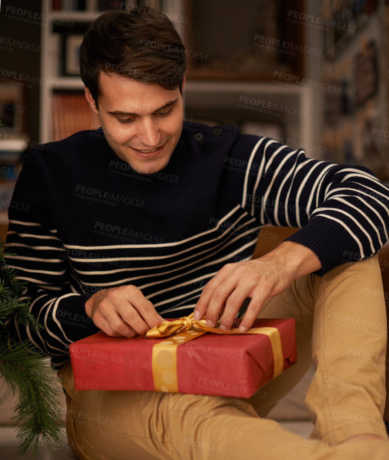 Buy stock photo Shot of a handsome young man getting ready for Christmas
